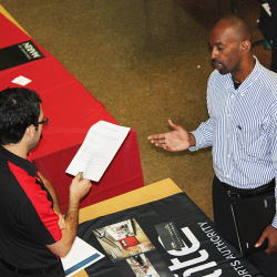 Two people discussing a resume at a career fair