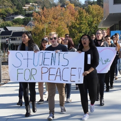 Students walking with signs and banners