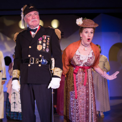 Ship captain and woman on stage in a performance