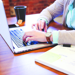 person typing on a laptop
