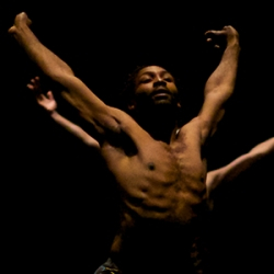 Dancers in front of black background