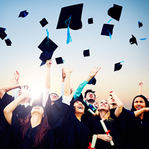 Graduates throwing caps in the air